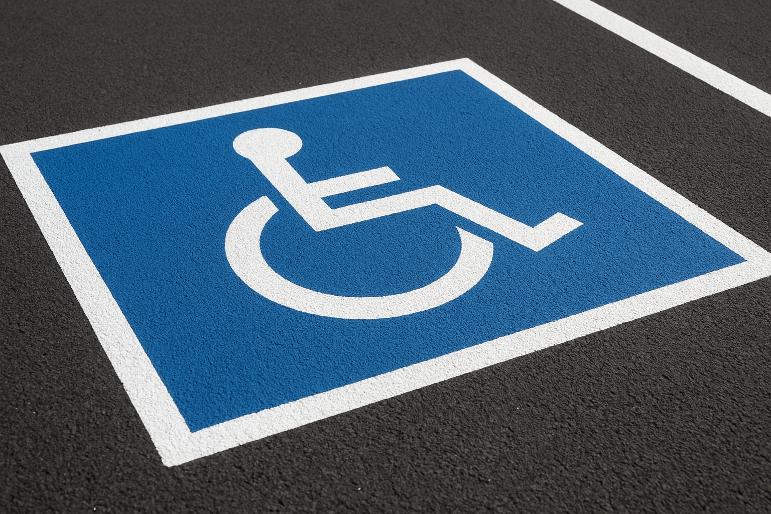 ADA compliant handicap parking space with blue accessibility markings and signage