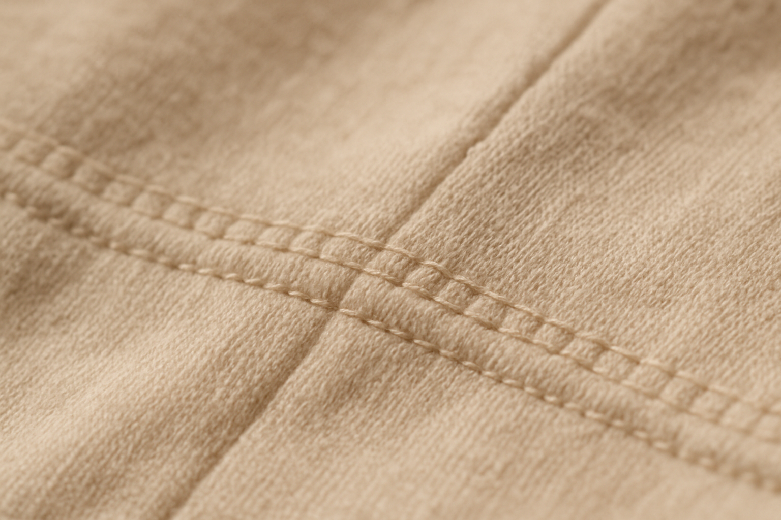 Close-up of reinforced stitching and organic fabric texture on a quality children's garment