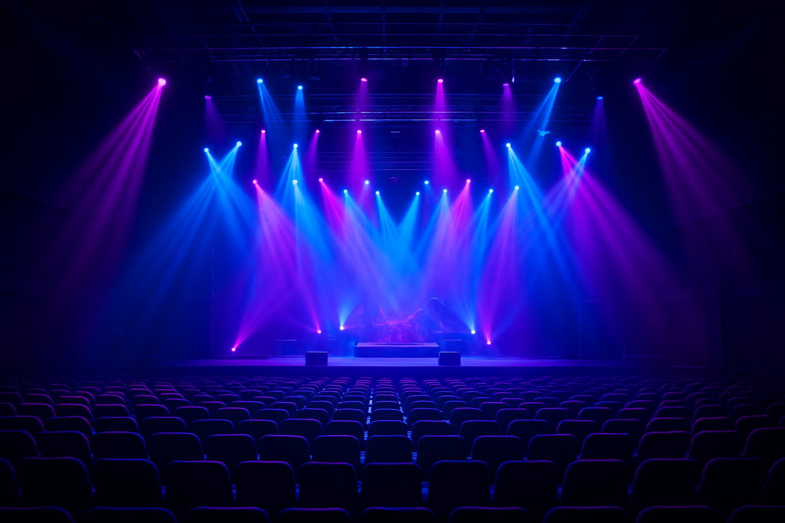 Professional stage lighting setup for a live event, showcasing colorful LED fixtures used by event AV specialists