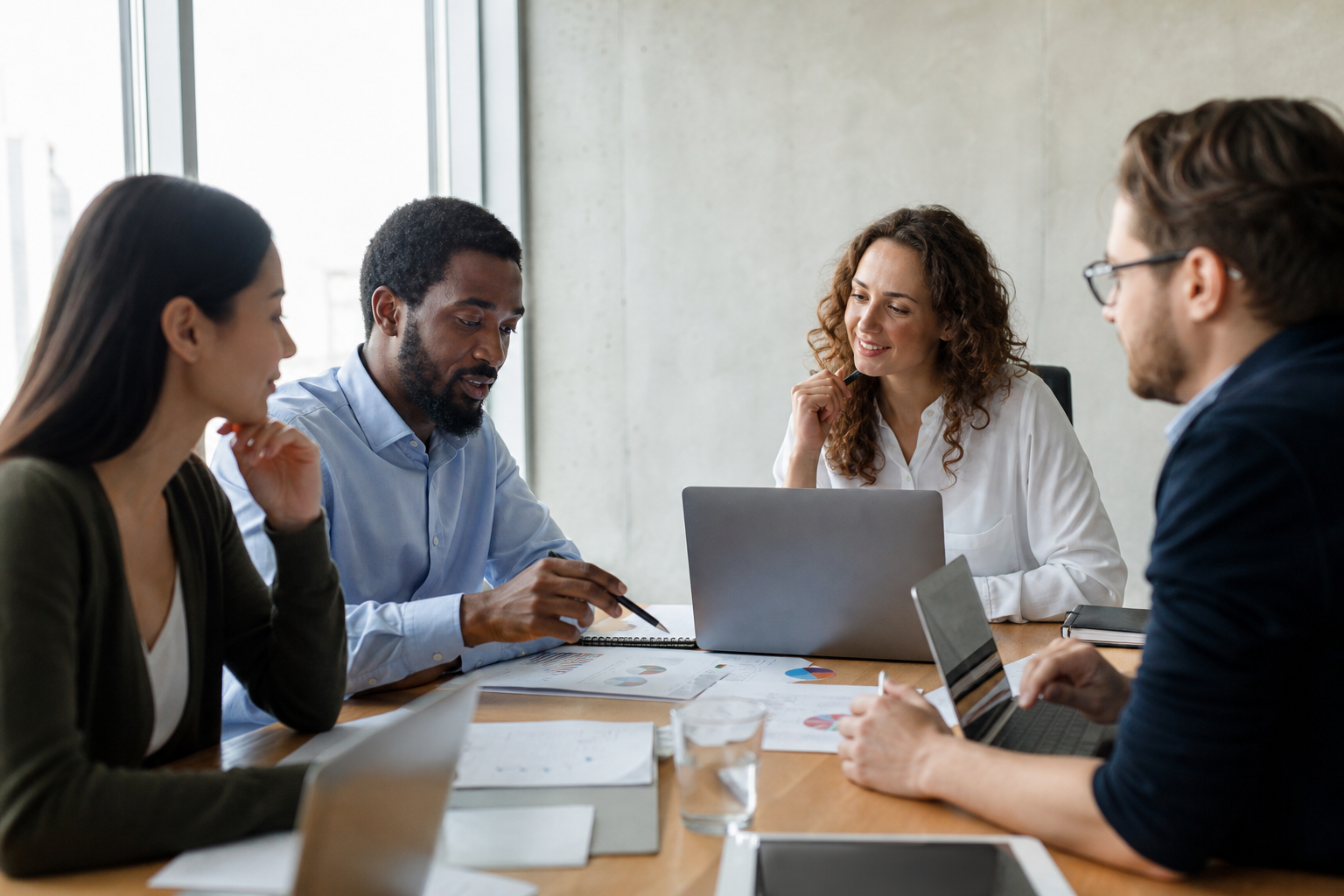 Team members discussing workplace culture enhancement ideas around a conference table